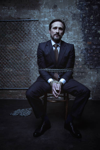 istock Unimpressed businessman imprisoned somewhere dark 656838556