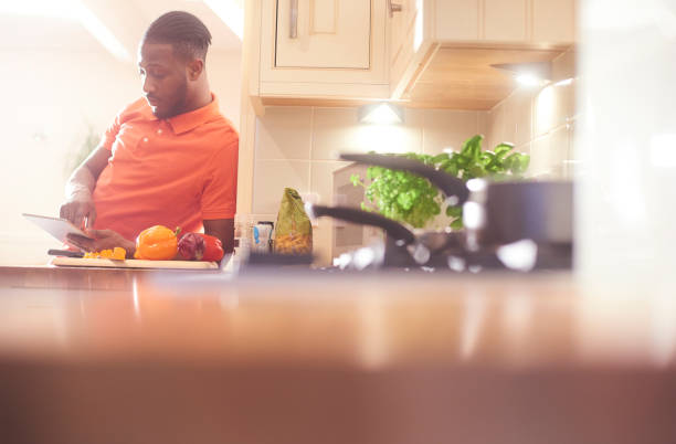 istock Reading the recipe on his digital tablet 656842396