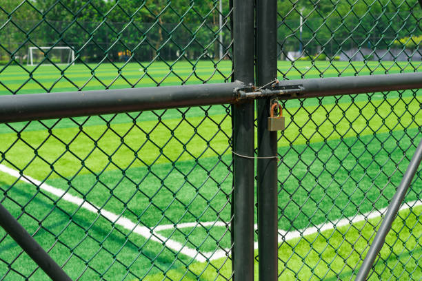 istock soccer field being locked with padlock 656846280