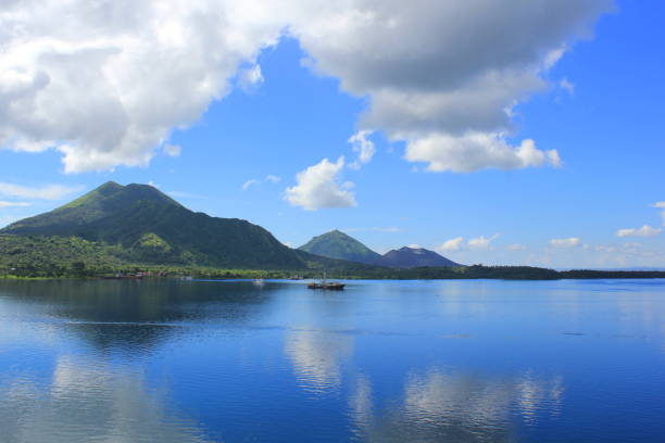 View of Mount Tavurvur From Rabaul Across Blanche Bay The view of Mount Tavurvur looking across Blanche Bay from Rabaul. new britain island stock pictures, royalty-free photos & images