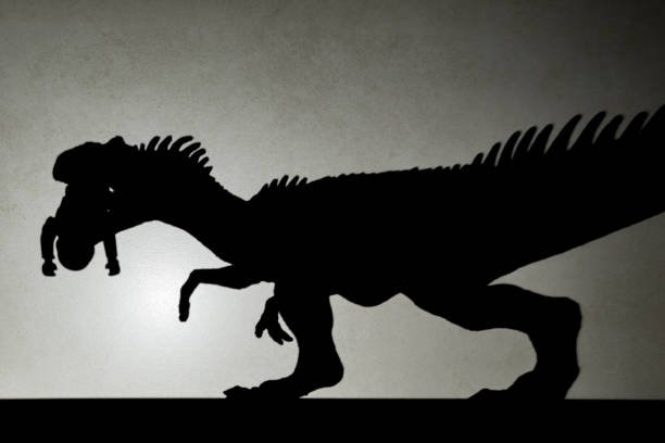 istock shadow of allosaurus biting a body  on wall 656851844