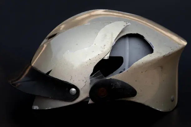 broken motobike helmet on a black background
