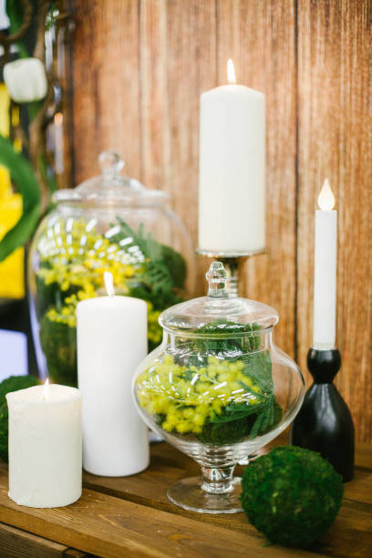 istock Candlestick with candle and mimosa in vase. 656861242