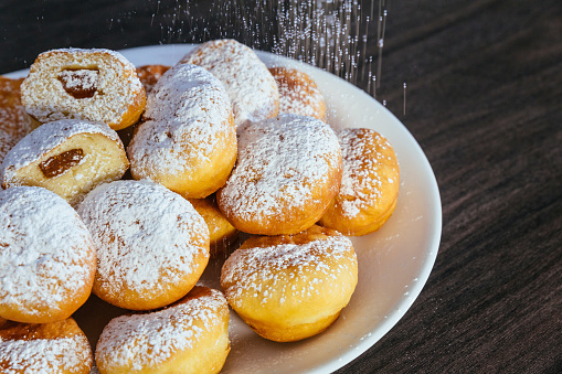 heap of marmalade filled bismarck donuts on white plate donuts with jam