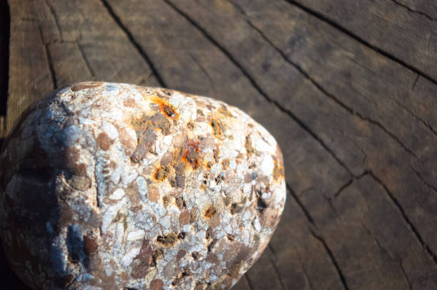 Spa beautiful and unusual decorative pebbles on the old cracked wooden background