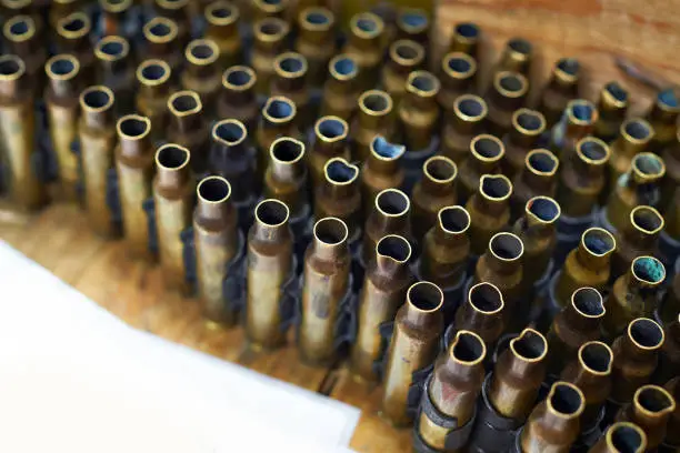 Brass cases of cartridges in a machine-gun tape