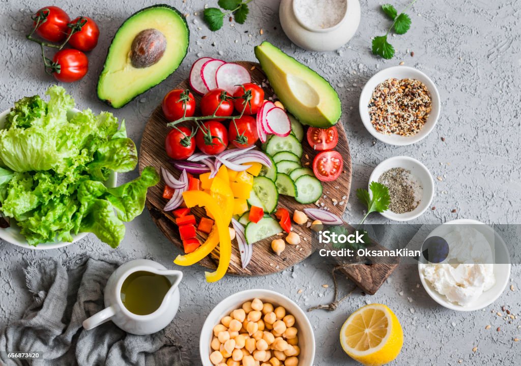 Ingredients for spring vegetable buddha bowl. Delicious healthy food.  On a gray background, top view Mediterranean Food Stock Photo