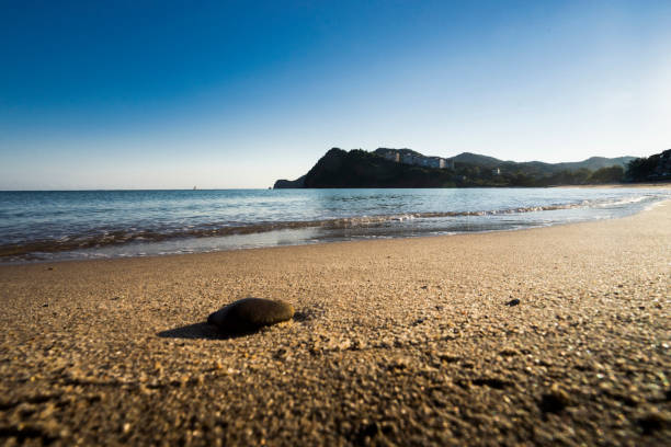 Rocks, the fishing boat and sea stock photo