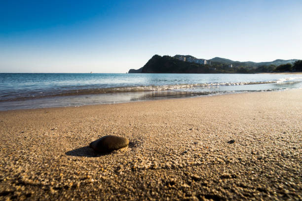 Rocks, the fishing boat and sea stock photo