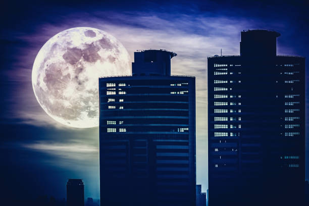 istock Silhouettes of two skyscrapers construction with supermoon. 656882178