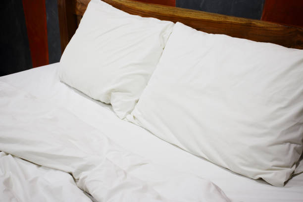 istock Messy white bed and pillow, in the morning 656885922