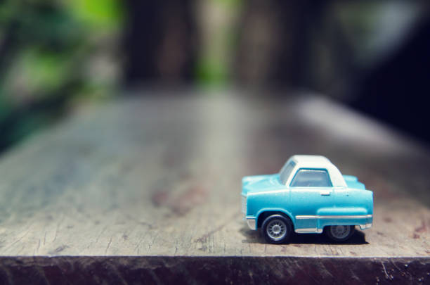istock toy car on woodden panel with nature background 656888636