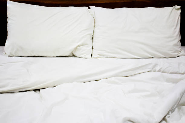 istock Messy white bed and pillow, in the morning 656892198