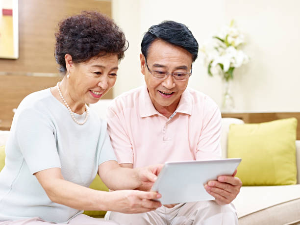 istock senior asian couple using tablet at home 656897984