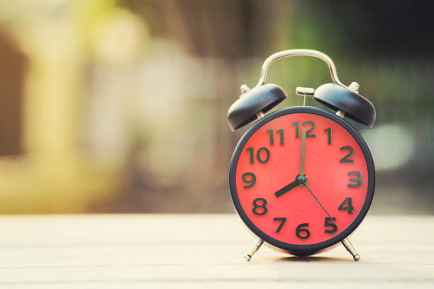 istock Retro alarm clock on wooden table, vintage style 656902220