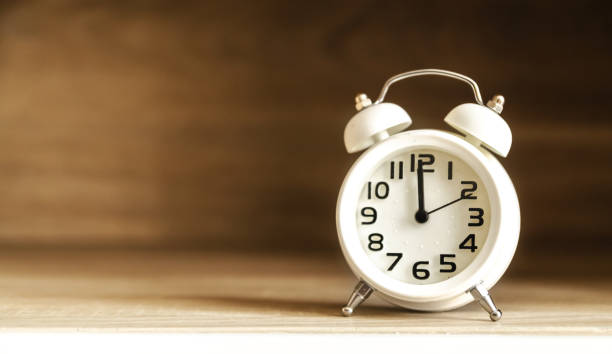 istock Retro alarm clock on a table. Photo in retro color image style 656902690