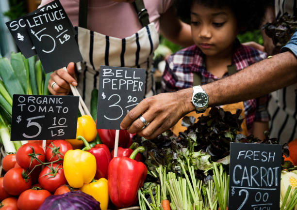istock Little Boy Selling Vegetable at Market 656905840