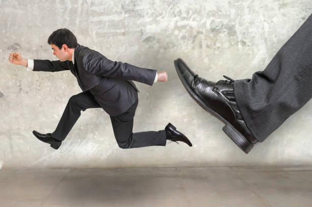 istock Small businessman running away from a boss pressure 656909630
