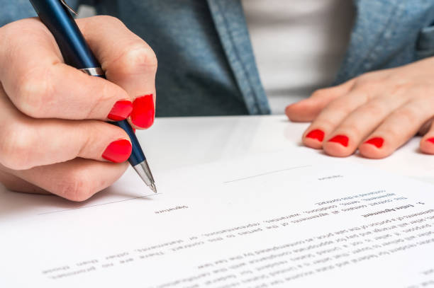 istock Female hand signing contract to conclude a deal 656912158