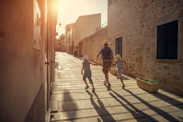 istock Father with two sons visiting mediterranean town. 656915360