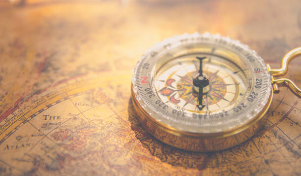 istock Old vintage retro golden compass on ancient map 656915390
