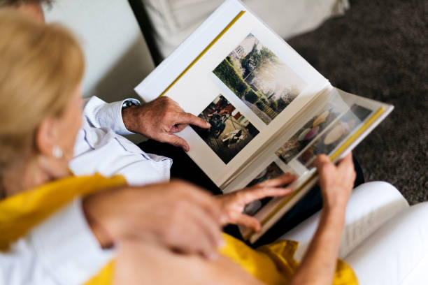 Senior Couple Look Photo Album ***NOTE TO INSPECTOR: The images on the album are our images. There are no people in the photos. Dogs - Stock photo ID:544657062*** photo album photos stock pictures, royalty-free photos & images