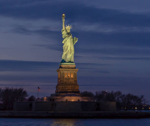 Statue of Liberty at sunset. stock photo