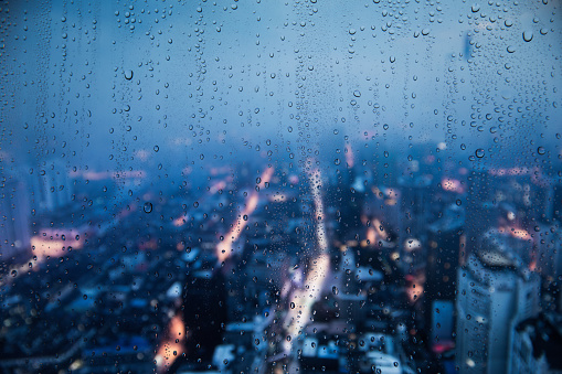 Rainy window with a blured city background