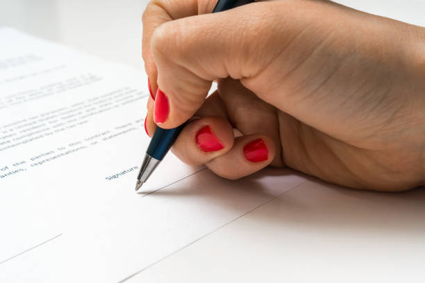 istock Female hand signing contract to conclude a deal 656919360