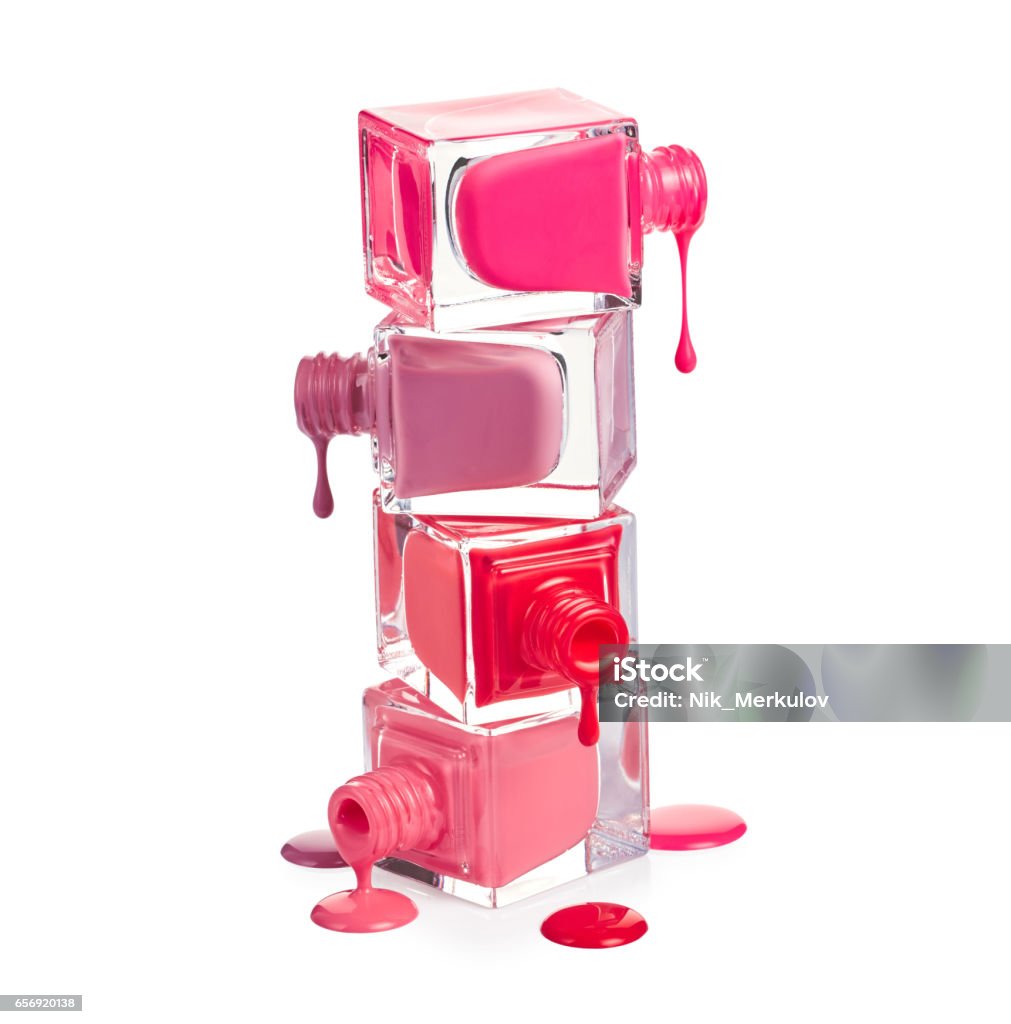 Nail polish dripping from stacked bottles Nail polish dripping from stacked bottles isolated on white background Nail Polish Stock Photo