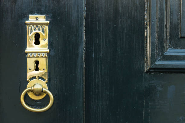 istock Dark green door with golden key hole 656932650