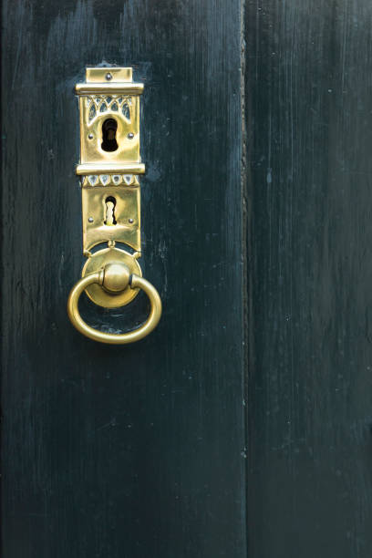 istock Dark green door with golden key hole 656932736