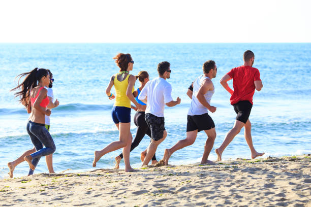 istock Group of sportmen running on beach 656936758