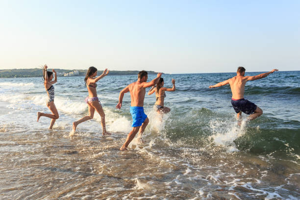 istock Friends jumping in water 656936814