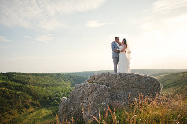 istock wedding couple on the rock 656937100