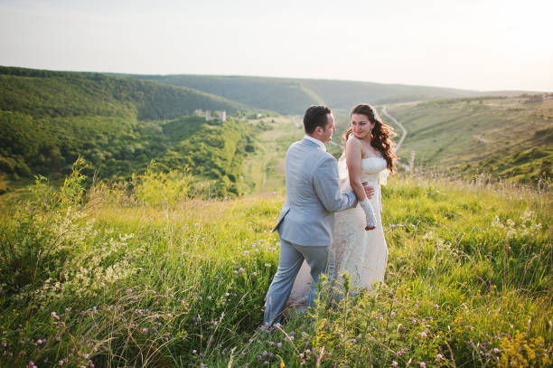 istock Newlyweds on sunset with flowers 656937138