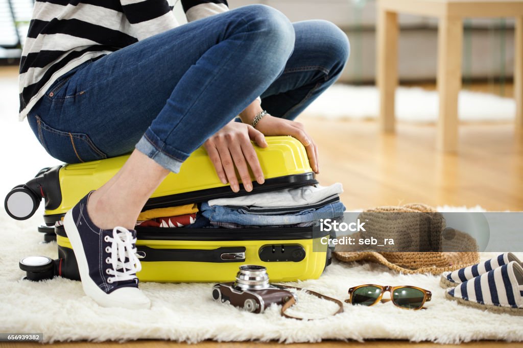 Preparation travel suitcase at home Suitcase Stock Photo