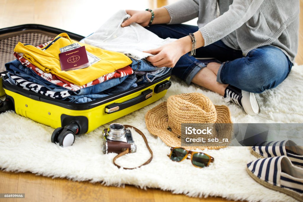 Preparation travel suitcase at home Suitcase Stock Photo