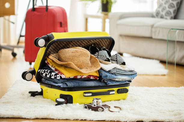 Preparation travel suitcase at home stock photo