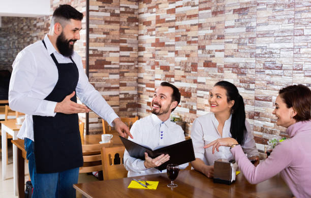 istock Waiter serving rural restaurant guests at table 656943452