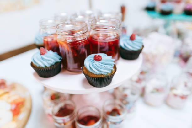 istock Delicious wedding reception candy bar Dessert table for a wedding party. Cakes with raspberries and strawberry jam 656943748