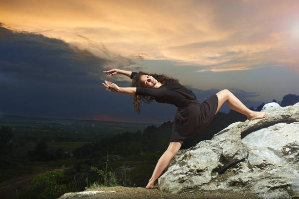 istock young, curly dancing girl dancing in the mountains 656947580