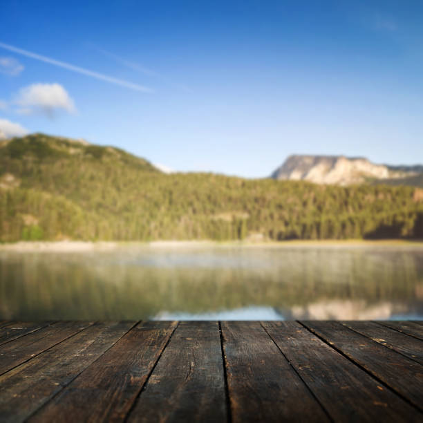 istock Dark wooden floor and defocused landscape background 656955248