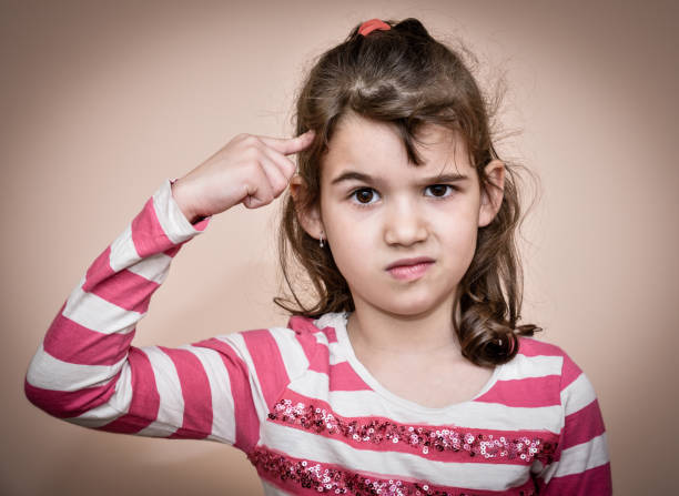 istock Young girl with the index finger on her head 656959002