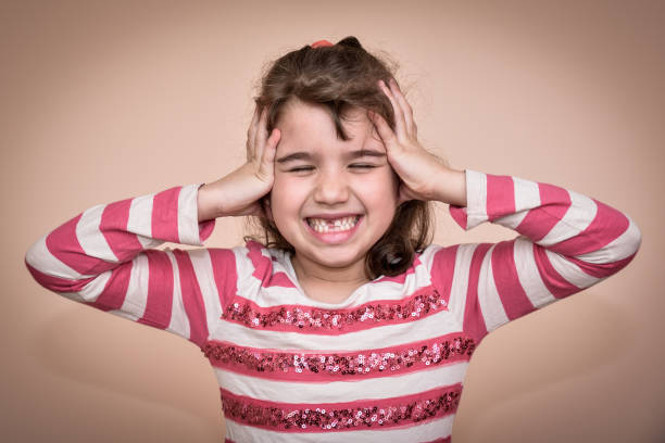 istock Young girl covering her ears 656959010