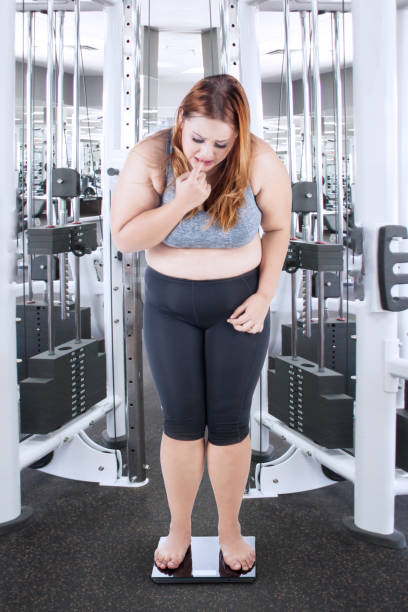 istock Overweight girl stands on weighing scale 656968438