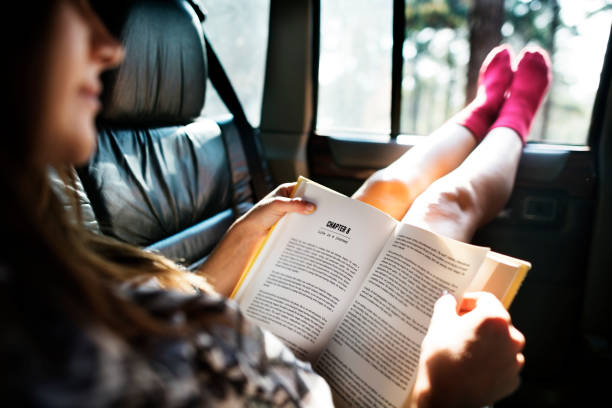 istock Girl Reading Book Inside Car Concept 656968626