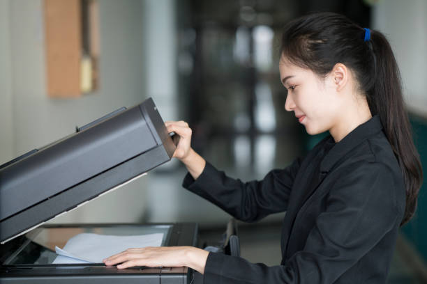 istock asian woman secretary using copy machine in the office 656969306