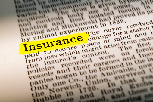 The word Insurance - dictionary definition highlighted with yellow marker