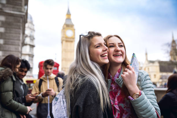 College Students on travel to London Group of young teenagers enjoying a school trip in London, they're visiting Westminster areas. london girl stock pictures, royalty-free photos & images
